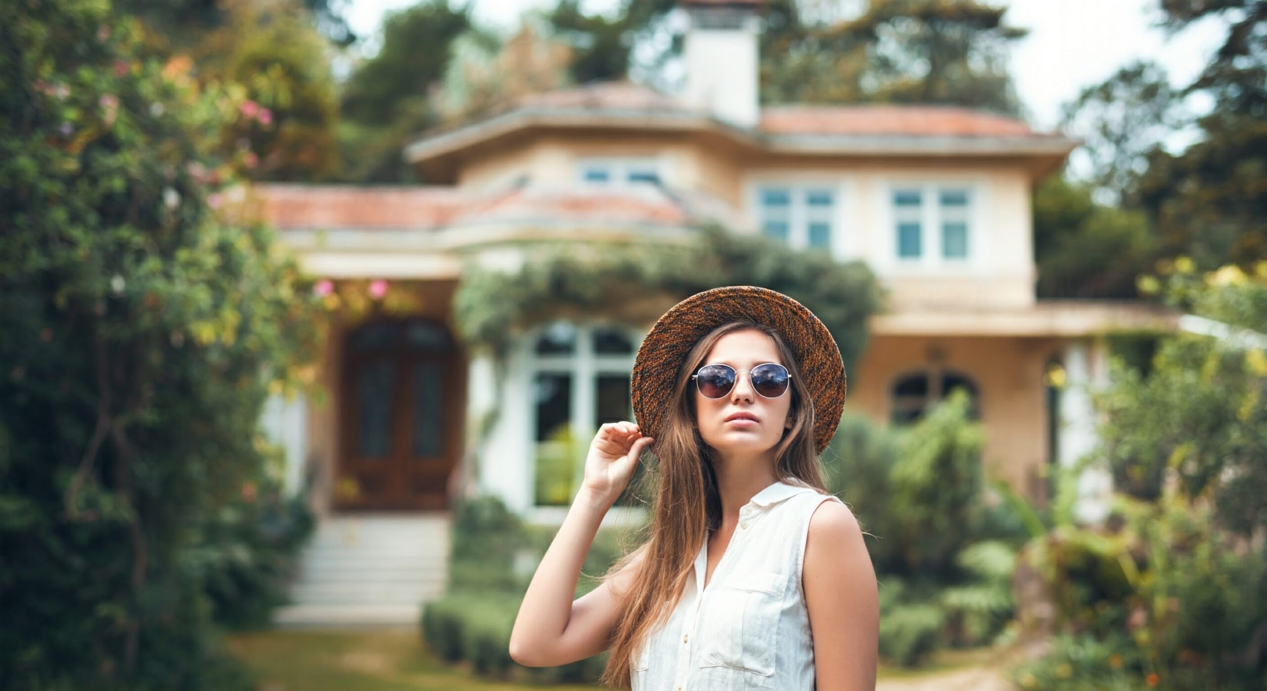 Woman standing outside the customize pre-designed house plan.